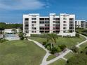Condo building showcasing a specific unit with balcony at 2020 Harbourside Dr # 424, Longboat Key, FL 34228