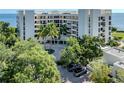 Condo building with lush landscaping and waterfront access at 2020 Harbourside Dr # 424, Longboat Key, FL 34228