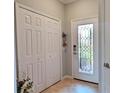 Bright entryway with coat closet and elegant stained-glass door at 20234 Lagente Cir, Venice, FL 34293
