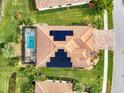 Top-down view of house with solar panels, pool, and landscaped yard at 20323 Granlago Dr, Venice, FL 34293