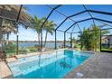 Screened-in pool and spa with a lake view at 20323 Granlago Dr, Venice, FL 34293