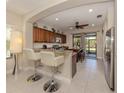 Kitchen with granite countertops, stainless steel appliances, and breakfast bar at 205 Carlino Dr, Nokomis, FL 34275