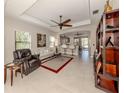 Spacious living room with leather seating, hardwood floors, and a view to the kitchen at 205 Carlino Dr, Nokomis, FL 34275