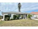 One-story home with a gray roof, white walls, and well-maintained landscaping at 212 San Carlos Ave, North Port, FL 34287