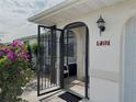 Front entry with an ornate black metal gate and terracotta house number at 212 San Carlos Ave, North Port, FL 34287