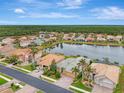 Bird's-eye view of a residential neighborhood with a lake at 2224 Mesic Hammock Way, Venice, FL 34292