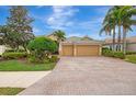 Two-story house with a double-car garage and mature trees at 2224 Mesic Hammock Way, Venice, FL 34292