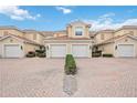 Three-unit townhome building with brick pavers and two-car garages at 23253 Banbury Way # 301, Venice, FL 34293