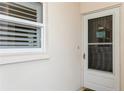 Inviting condo entrance with a screen door and window at 244 Saint Augustine Ave # 107, Venice, FL 34285