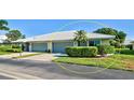 Exterior of a two-car garage villa with a landscaped yard at 3117 Heron Shores Dr, Venice, FL 34293