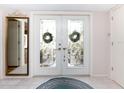 Elegant entry with double doors featuring etched glass and a decorative rug at 315 Park N Blvd, Venice, FL 34285