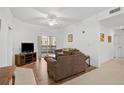 Living room featuring hardwood floors, a sofa, and access to a balcony at 3730 Cadbury Cir # 300, Venice, FL 34293