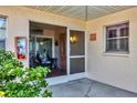 Front door entrance with a screened porch and seating area at 460 Base E Ave # 113, Venice, FL 34285
