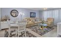 Light and airy living room with comfortable seating and a dining area at 460 Base E Ave # 113, Venice, FL 34285
