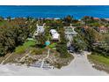 Aerial of beachfront community; shows beach, pool, and building at 5125 Gulf Of Mexico Dr # 7, Longboat Key, FL 34228