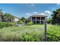 Back exterior showcasing a two-story home with private pool at 5125 Gulf Of Mexico Dr # 7, Longboat Key, FL 34228