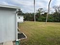 Large grassy backyard with mature trees, offering privacy at 607 Cervina Dr, Venice, FL 34285