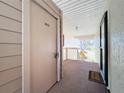 Hallway with storage unit and condo entry door at 654 Bird Bay E Dr # 206, Venice, FL 34285