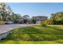 Two-story house with a large driveway and lush lawn at 690 Percheron, Nokomis, FL 34275
