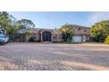 Two-story house with a paver driveway and tropical landscaping at 690 Percheron, Nokomis, FL 34275