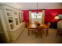 Bright dining area with a built-in hutch and wood dining table at 701 S Green Cir, Venice, FL 34285