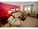 Living room features a sofa, two armchairs, and a coffee table at 701 S Green Cir, Venice, FL 34285