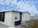 Side view of a mobile home, showing additional exterior features at 723 Locarno Dr, Venice, FL 34285