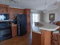Spacious kitchen with dark wood cabinets and island at 779 N Green Cir, Venice, FL 34285