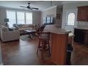 Living room with beige couch and wood flooring at 779 N Green Cir, Venice, FL 34285