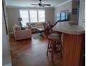 Living room with beige couch and wood flooring at 779 N Green Cir, Venice, FL 34285