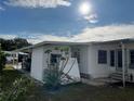 Side view of the manufactured home showing additional landscaping at 788 Cervina Dr, Venice, FL 34285