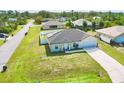 A charming single-story home with a well-maintained lawn and an attached garage at 8307 Glover Ave, North Port, FL 34291