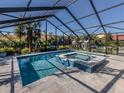 Screened-in pool and spa with tiled accents at 900 Osprey St, Venice, FL 34285