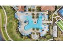 Overhead view of a large resort-style pool with surrounding lounge chairs at 10058 Crooked Creek Dr # 201, Venice, FL 34293