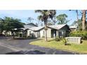 View of a condo building with lush landscaping at 112 Jose Gaspar Dr # 112, Englewood, FL 34223