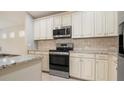 Modern kitchen with granite countertops and stainless steel appliances at 12460 Shimmering Oak Cir, Venice, FL 34293