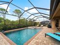 Screened pool and spa with lounge chairs and patio furniture at 12950 Basilica Dr, Venice, FL 34293