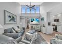 Bright living room features vaulted ceilings, coastal decor, and beachy hues at 1555 Tarpon Center Dr # 238, Venice, FL 34285