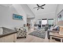 Living room showing open floor plan with coastal decor and sliding glass doors at 1555 Tarpon Center Dr # 238, Venice, FL 34285