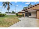 Landscaped yard and front view of single-story home with carport at 1700 Curry Ave # 37, Nokomis, FL 34275