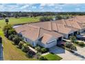 Community of tan houses with tile roofs near golf course at 1891 San Silvestro Dr, Venice, FL 34285
