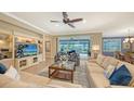 Spacious living room with light beige sectional sofa and built-in entertainment center at 19500 Petrino St, Venice, FL 34293