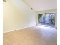 Bright living room, tile floors, access to patio at 2066 Sunset Point Rd # 91, Clearwater, FL 33765