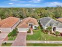 Attractive home with tile roof, driveway, and lush landscaping at 2136 Mesic Hammock Way, Venice, FL 34292