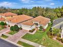 Single-Gathering home with a clay tile roof, two-car garage, and a nicely landscaped yard at 2136 Mesic Hammock Way, Venice, FL 34292