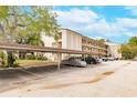 Covered parking area with several cars parked under at 2280 Stickney Point Rd # 437, Sarasota, FL 34231