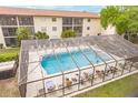 Community pool with a screened enclosure at 2280 Stickney Point Rd # 437, Sarasota, FL 34231