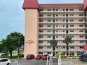Side view of a multi-story building with palm trees and parking at 232 Saint Augustine Ave # 105, Venice, FL 34285