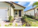 Front entry with walkway, landscaping, and a dark door at 232 Teramo Way, Nokomis, FL 34275
