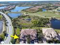 Aerial view showcasing community, lake, golf course, and subject property at 23619 Awabuki Dr, Venice, FL 34293